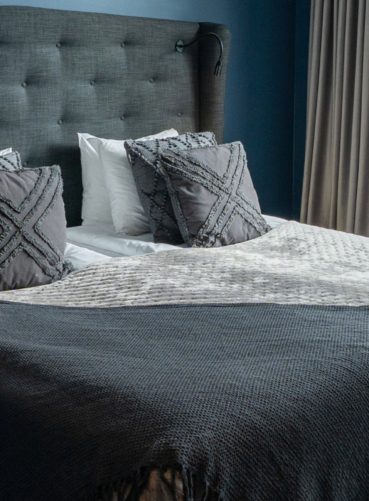 Closeup of bed in superior room with a french balcony